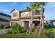 Charming two-story home featuring a stone facade, covered porch and well-manicured landscaping at 3952 Aldea Way, Wesley Chapel, FL 33543