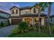 Charming two-story home featuring a stone facade, covered porch and well-manicured landscaping at 3952 Aldea Way, Wesley Chapel, FL 33543