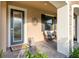 Inviting front porch with stone accents, comfortable seating, and lush landscaping at 3952 Aldea Way, Wesley Chapel, FL 33543