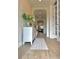 Bright hallway with wood-look tile flooring, arched entryway, and elegant wainscoting details at 3952 Aldea Way, Wesley Chapel, FL 33543