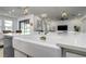 Modern kitchen with a farmhouse sink, stylish faucet, and open to the living area at 3952 Aldea Way, Wesley Chapel, FL 33543