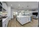 Modern kitchen featuring a large island, white cabinetry, and open layout at 3952 Aldea Way, Wesley Chapel, FL 33543