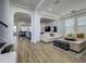 Bright living room featuring sleek white sofas and an open floor plan at 3952 Aldea Way, Wesley Chapel, FL 33543