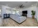 Modern living room with a large sectional, TV, and stylish decor at 3952 Aldea Way, Wesley Chapel, FL 33543