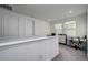 Loft area featuring carpet flooring, multiple windows, and two closet doors at 3952 Aldea Way, Wesley Chapel, FL 33543