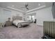 Spacious main bedroom with tray ceiling featuring a sitting area and ensuite bathroom at 3952 Aldea Way, Wesley Chapel, FL 33543