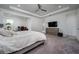 Spacious main bedroom featuring a tray ceiling, ceiling fan, and adjacent office space at 3952 Aldea Way, Wesley Chapel, FL 33543