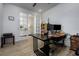 Bright office features an expansive desk area with french doors that lead to the home's foyer at 3952 Aldea Way, Wesley Chapel, FL 33543