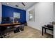 Well-lit home office features bold blue walls, neutral floors, and ample workspace at 3952 Aldea Way, Wesley Chapel, FL 33543