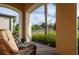 Inviting porch with wicker chair offering a relaxed outdoor living space at 3952 Aldea Way, Wesley Chapel, FL 33543