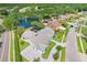 Breathtaking aerial view of a home near a serene pond, surrounded by lush trees, offering tranquility and privacy at 4012 Wellington Pkwy, Palm Harbor, FL 34685