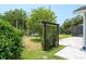 Landscaped backyard with a black iron gate and a tranquil view of the pond at 4012 Wellington Pkwy, Palm Harbor, FL 34685