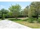 Manicured backyard with lawn and trees at 4012 Wellington Pkwy, Palm Harbor, FL 34685