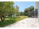 Paved outdoor patio with view of the pond and fountain at 4012 Wellington Pkwy, Palm Harbor, FL 34685