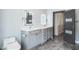 Modern bathroom featuring dual vanities, custom mirrors, and spacious walk-in closet at 4012 Wellington Pkwy, Palm Harbor, FL 34685