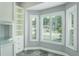 Bathroom with large windows, custom shelving, and neutral carpet at 4012 Wellington Pkwy, Palm Harbor, FL 34685