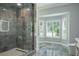 Elegant bathroom with marble shower and stylish window at 4012 Wellington Pkwy, Palm Harbor, FL 34685