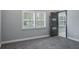 Bedroom with a window with white shutters and modern paneled door at 4012 Wellington Pkwy, Palm Harbor, FL 34685
