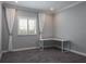Bright bedroom featuring a window with white shutters and matching curtains, and a modern L-shaped desk at 4012 Wellington Pkwy, Palm Harbor, FL 34685
