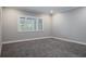 Bright bedroom with large window and neutral carpet at 4012 Wellington Pkwy, Palm Harbor, FL 34685