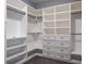 Spacious walk-in closet with custom shelving and drawers offers ample storage space at 4012 Wellington Pkwy, Palm Harbor, FL 34685