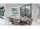 Dining room with a modern table set, showcasing seamless access to the screened outdoor entertainment area at 4012 Wellington Pkwy, Palm Harbor, FL 34685
