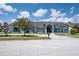 Beautiful single story home featuring a gray tile roof, landscaped yard and stone paver driveway at 4012 Wellington Pkwy, Palm Harbor, FL 34685