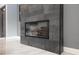 Close-up of a modern, tiled fireplace adding a touch of elegance to the living space at 4012 Wellington Pkwy, Palm Harbor, FL 34685