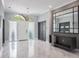 Bright foyer with marble flooring, modern lighting fixture, and decorative glass front door at 4012 Wellington Pkwy, Palm Harbor, FL 34685