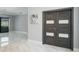 Foyer view features marble floors and modern double doors with glass accents at 4012 Wellington Pkwy, Palm Harbor, FL 34685