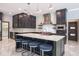Kitchen featuring an island with seating, stainless steel range hood, and tiled backsplash at 4012 Wellington Pkwy, Palm Harbor, FL 34685