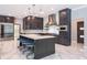 Modern kitchen with an island with seating, stainless steel appliances and dark wood cabinets at 4012 Wellington Pkwy, Palm Harbor, FL 34685