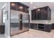 Kitchen featuring stainless steel refrigerator, wine cooler, dark cabinets and bright countertops at 4012 Wellington Pkwy, Palm Harbor, FL 34685