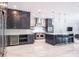 Bright, open kitchen with a large island, stainless steel appliances and dark wood cabinets at 4012 Wellington Pkwy, Palm Harbor, FL 34685