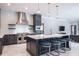 Spacious kitchen featuring an island with seating, stainless steel range hood, and tiled backsplash at 4012 Wellington Pkwy, Palm Harbor, FL 34685