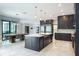 Open kitchen flowing into the dining area, featuring an island and stainless steel refrigerator at 4012 Wellington Pkwy, Palm Harbor, FL 34685