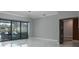 Spacious living room features marble floors and access to the outdoor patio at 4012 Wellington Pkwy, Palm Harbor, FL 34685