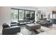 Bright living room showcasing contemporary furniture and a view of the screened-in pool area at 4012 Wellington Pkwy, Palm Harbor, FL 34685