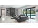 Elegant living room featuring modern furniture, fireplace, and access to the outdoor pool at 4012 Wellington Pkwy, Palm Harbor, FL 34685