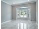 Bright living room with marble floors, bay window, and modern shutters at 4012 Wellington Pkwy, Palm Harbor, FL 34685