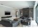 Stylish living room with a modern fireplace, sleek furniture, and a large screen television at 4012 Wellington Pkwy, Palm Harbor, FL 34685