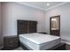 Comfortable main bedroom with a large bed, nightstands, and an ensuite bathroom at 4012 Wellington Pkwy, Palm Harbor, FL 34685