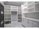 Well-organized pantry with white cabinets, shelving, and ample storage space at 4012 Wellington Pkwy, Palm Harbor, FL 34685