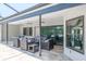Outdoor patio with comfortable seating, ceiling fans, and serene backyard view at 4012 Wellington Pkwy, Palm Harbor, FL 34685