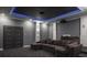 Cozy home theater featuring a sectional sofa, projector, and ambient blue lighting accents at 4012 Wellington Pkwy, Palm Harbor, FL 34685