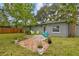 Charming backyard featuring a brick patio and colorful outdoor seating at 4324 S Clark Ave, Tampa, FL 33611