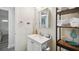 Bright bathroom featuring a modern sink, white vanity, and open shelving for storage and stylish design at 4324 S Clark Ave, Tampa, FL 33611