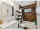 Updated bathroom featuring a modern sink, vanity, and a shower-tub combination with stylish brown tile at 4324 S Clark Ave, Tampa, FL 33611