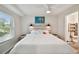 Bright bedroom with a wooden ceiling, a large window, a comfortable bed, and access to a bathroom at 4324 S Clark Ave, Tampa, FL 33611