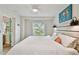 Cozy bedroom featuring a comfortable bed, white ceiling, and an open doorway with a turquoise door at 4324 S Clark Ave, Tampa, FL 33611